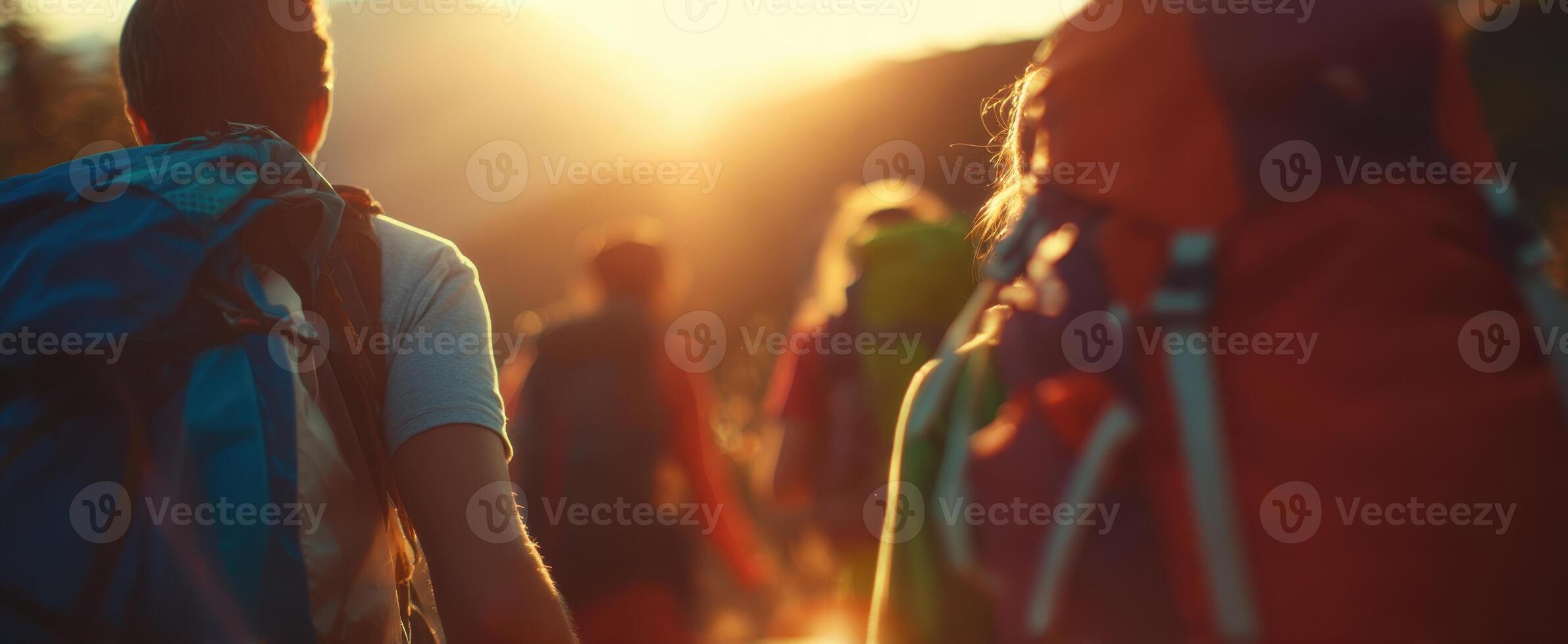 The hikers journeying through a stunning sunset in the mountains. photo