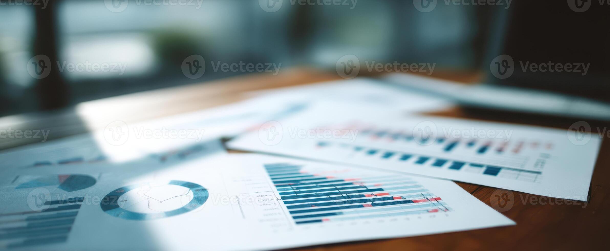 The documents displaying analytical data and graphs on a wooden desk. photo
