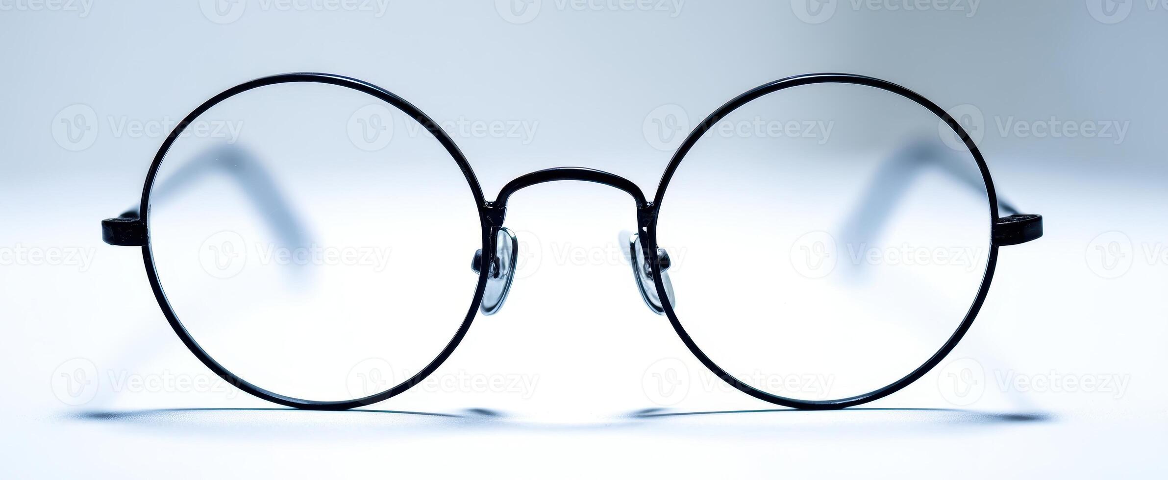 The elegant round glasses with a minimalist design on a bright background photo