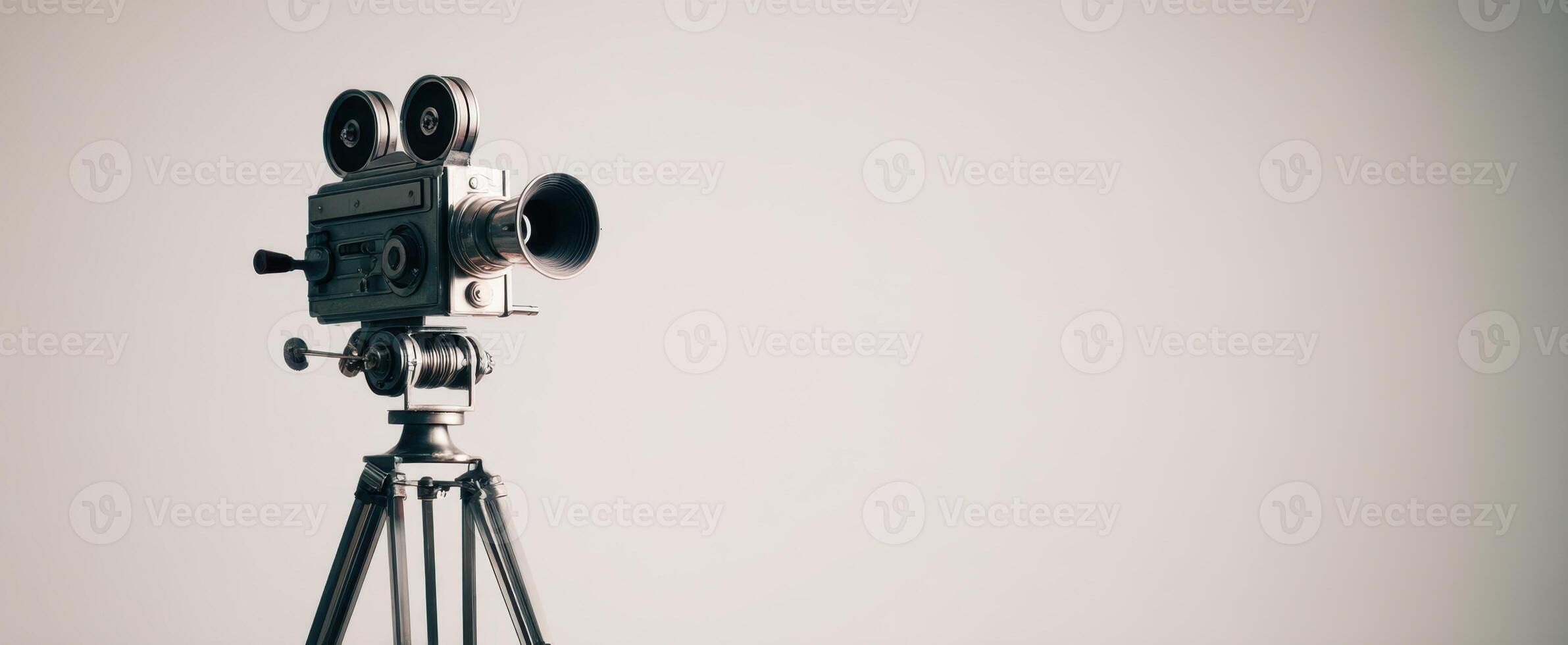 The vintage film camera on a tripod in a minimalist setting. photo