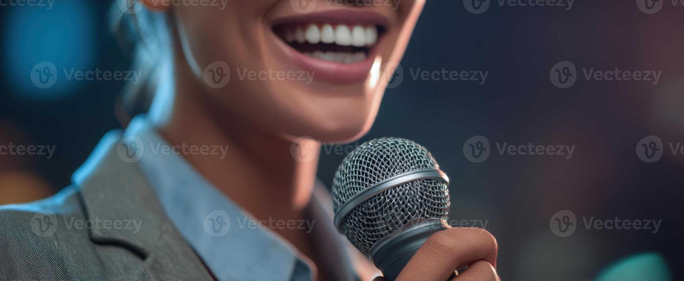 The confident woman holding a microphone while smiling on stage. photo