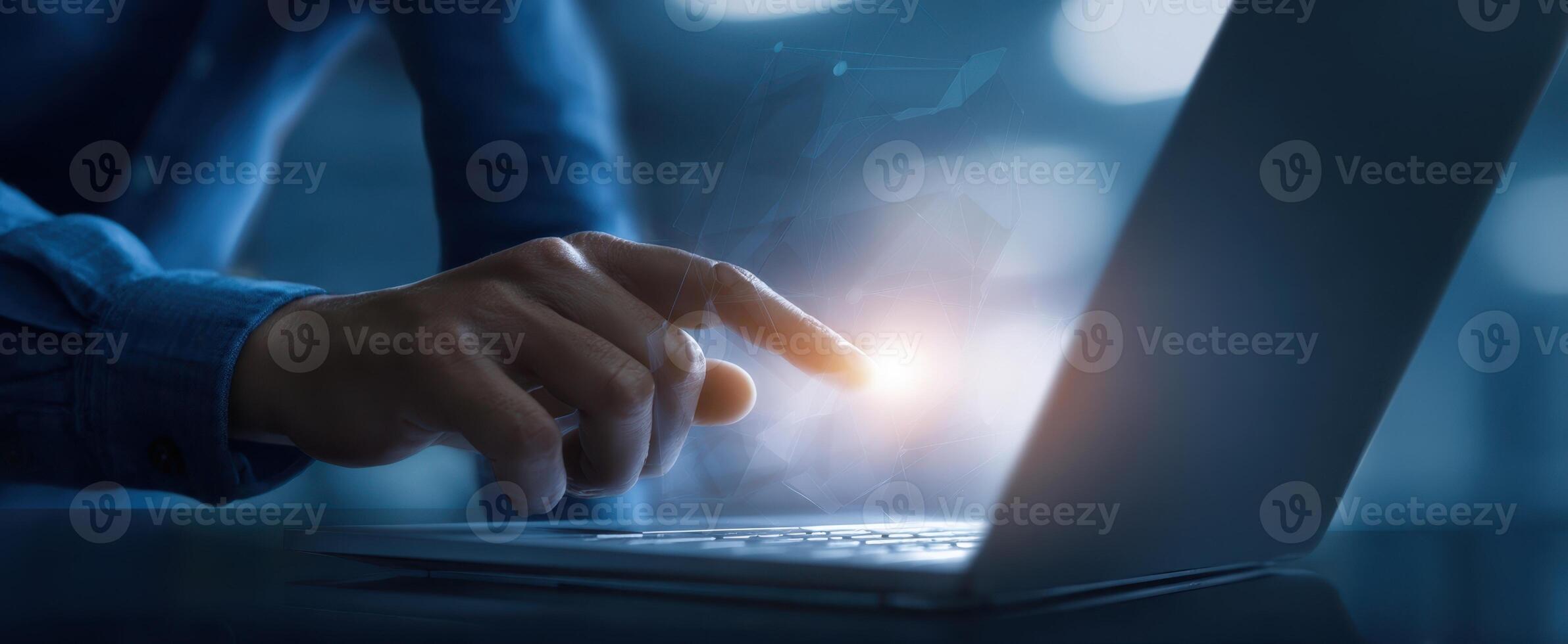 The hand interacting with a laptop in a modern digital workspace environment. photo