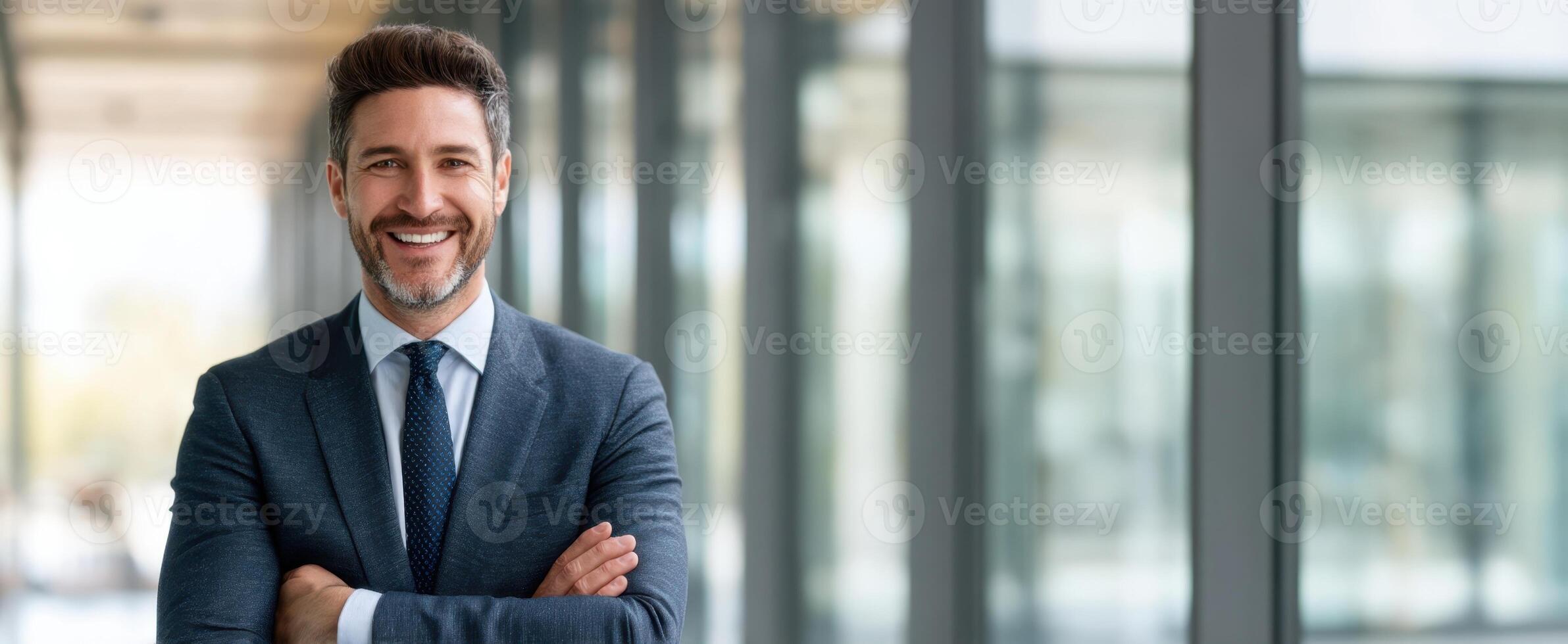 The businessman smiling confidently in a modern office environment. photo