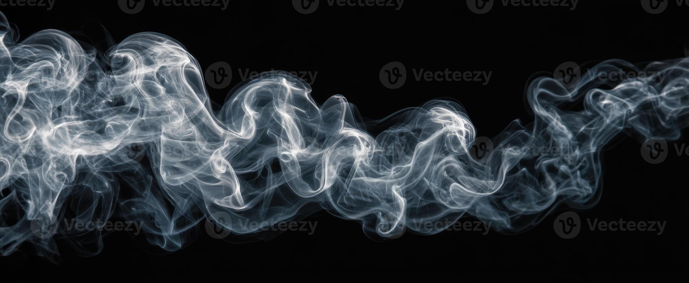 The Swirling Movement of Elegant Smoke Against a Dark Background photo