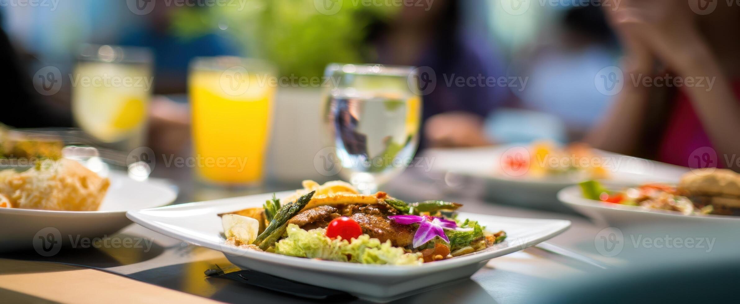The delicious gourmet meal beautifully presented on a dining table surrounded by drinks. photo