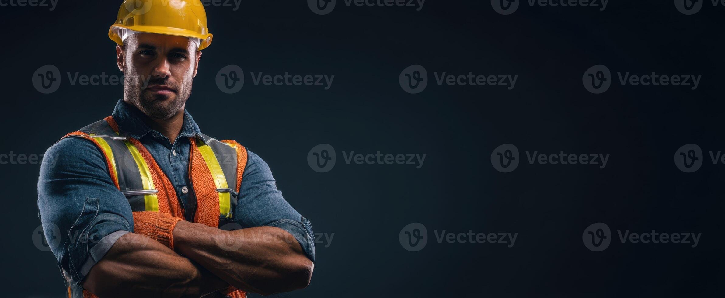 The confident construction worker poses with strength and determination in safety gear. photo