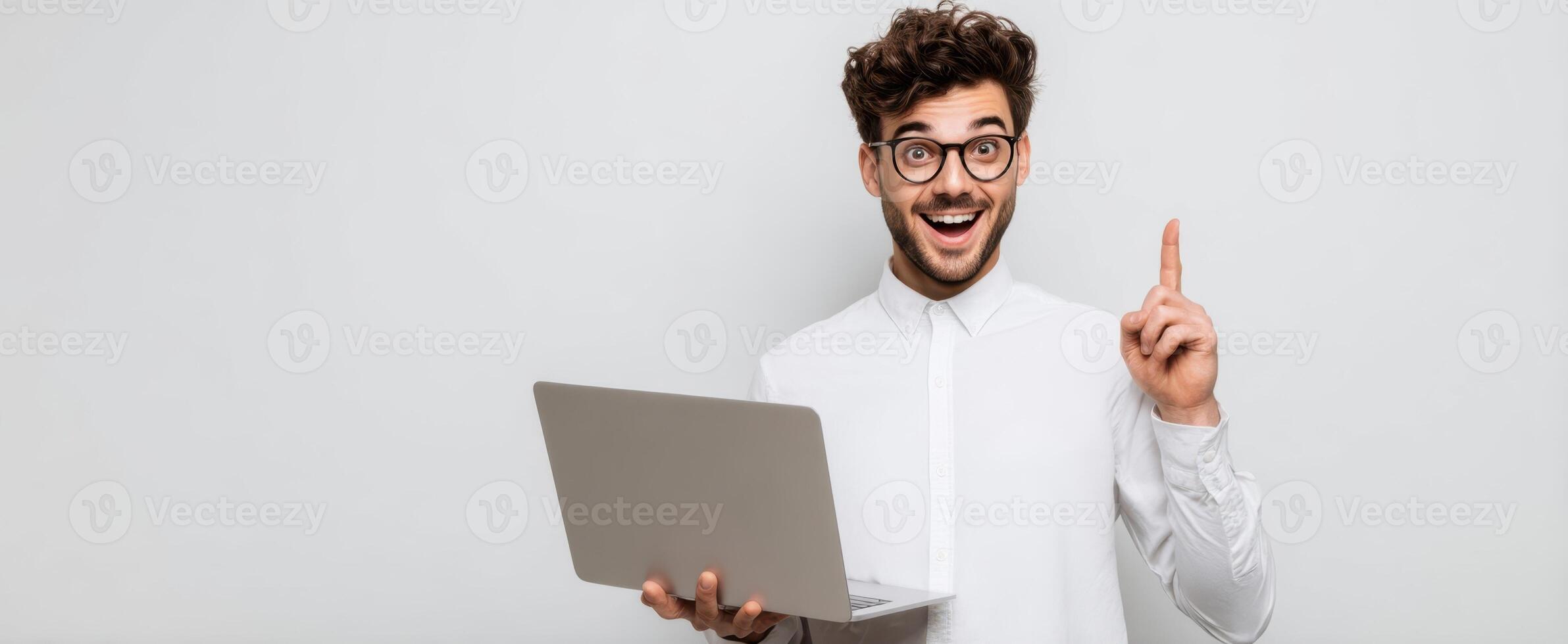 The young man with a laptop sharing a bright idea in a modern setting. photo