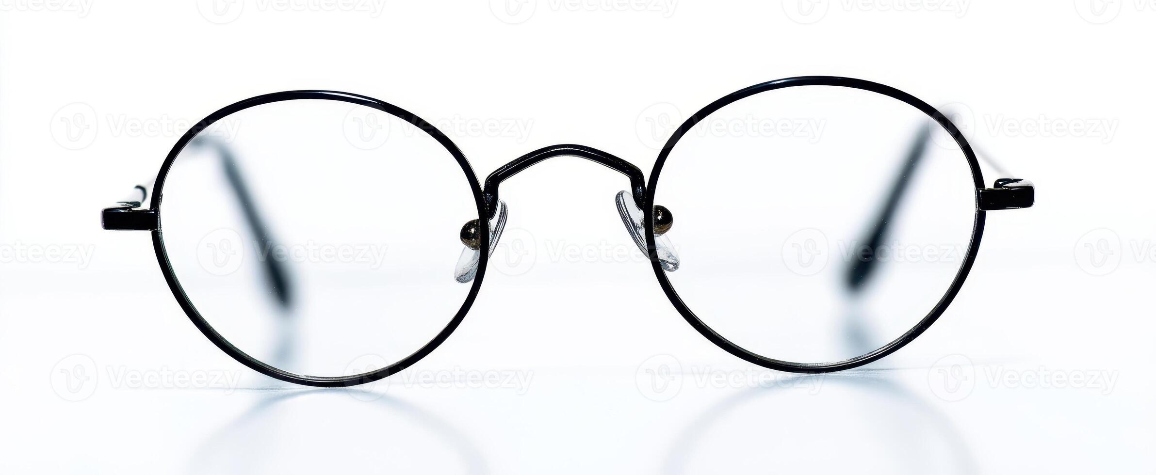 The elegant black round glasses with clear lenses on a clean background. photo