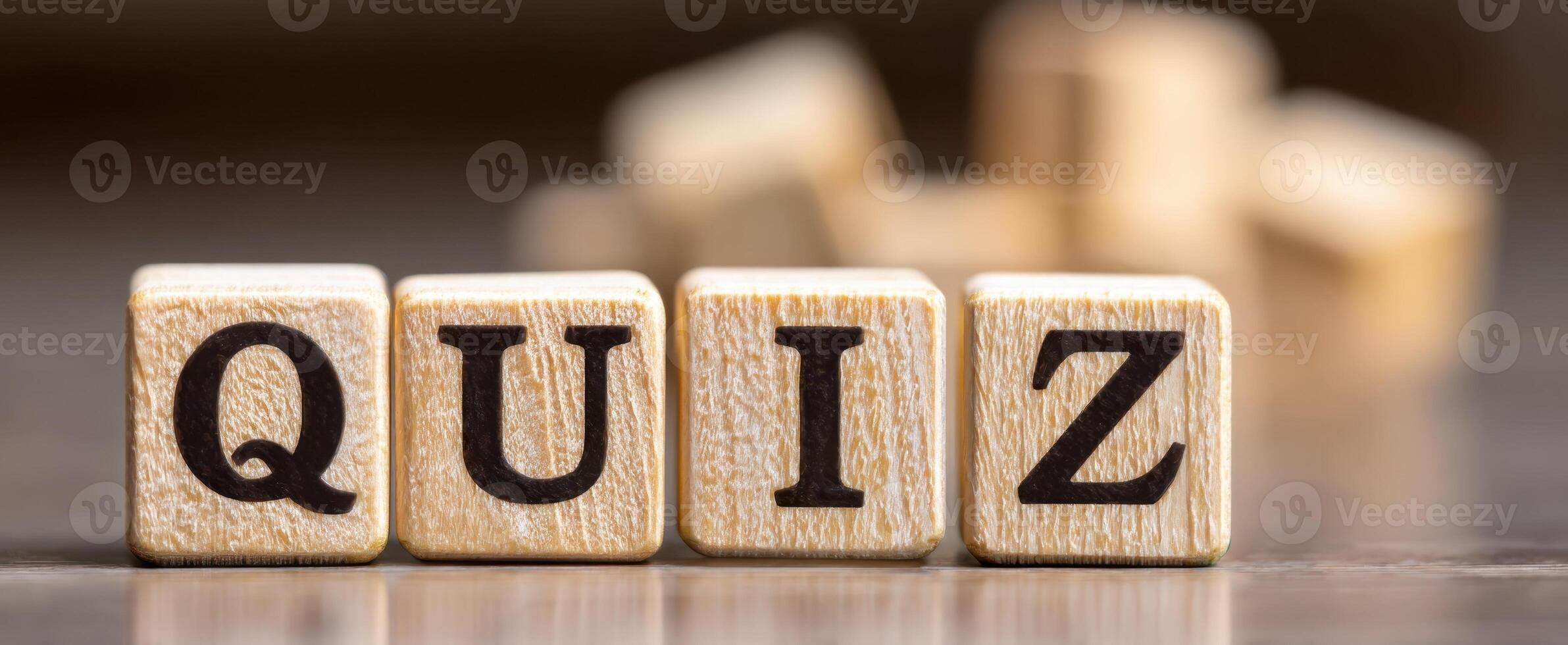 The colorful wooden blocks spell the word Quiz on a table. photo
