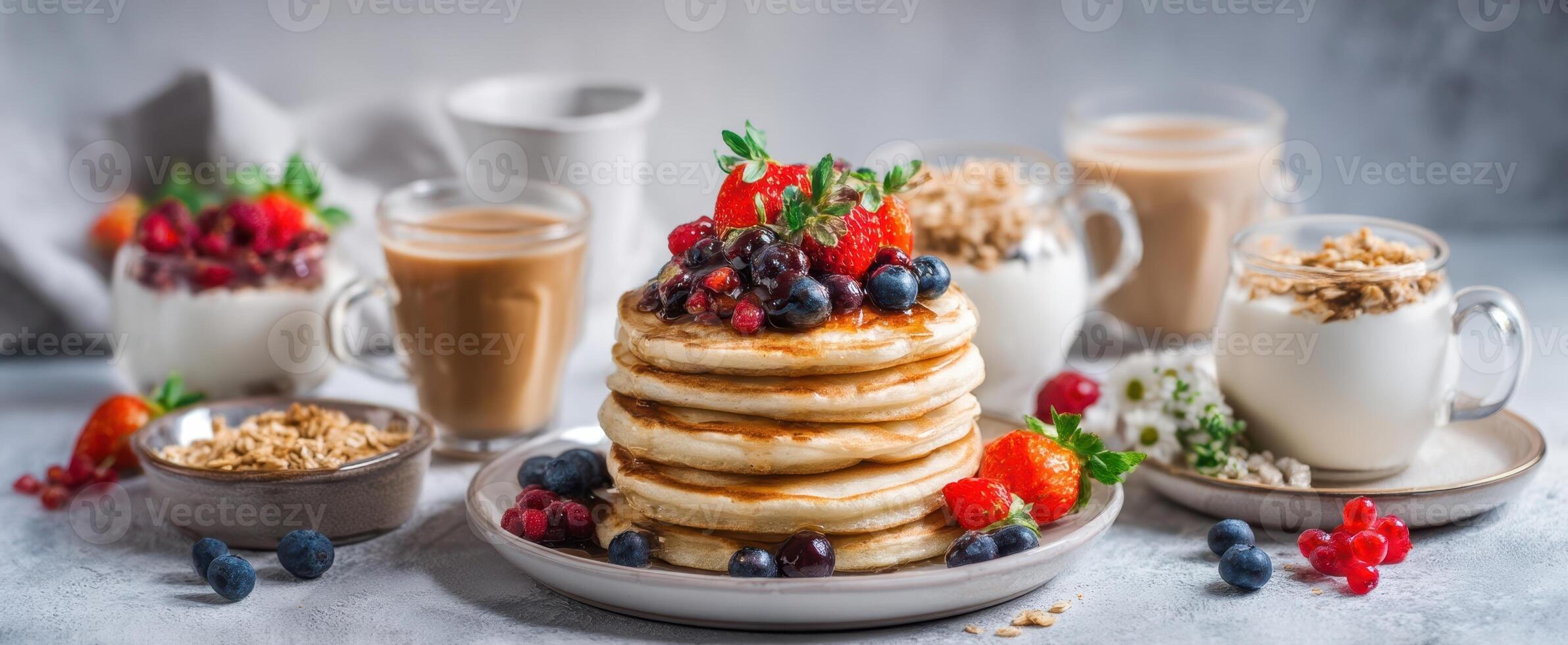 The delicious stack of fluffy pancakes topped with fresh berries and syrup. photo