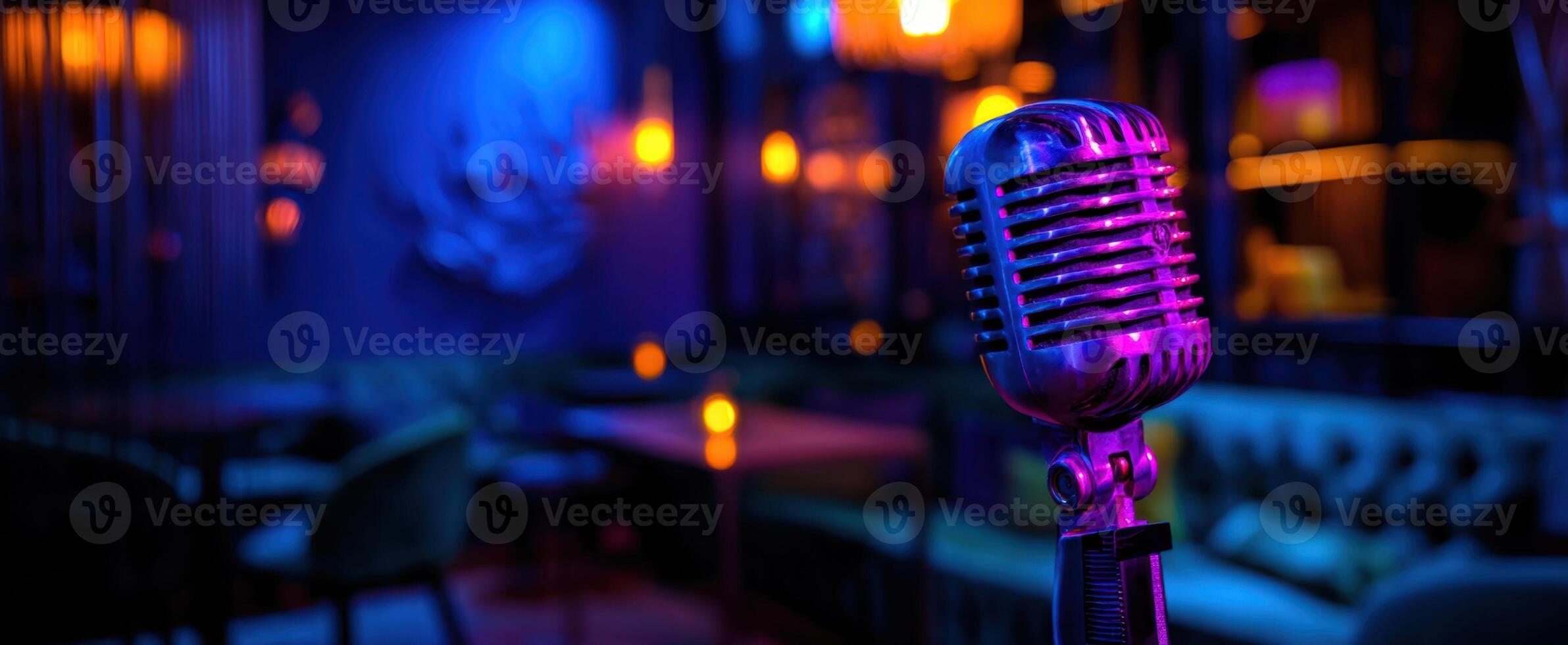 The vintage microphone in a stylish bar illuminated by colorful lights. photo
