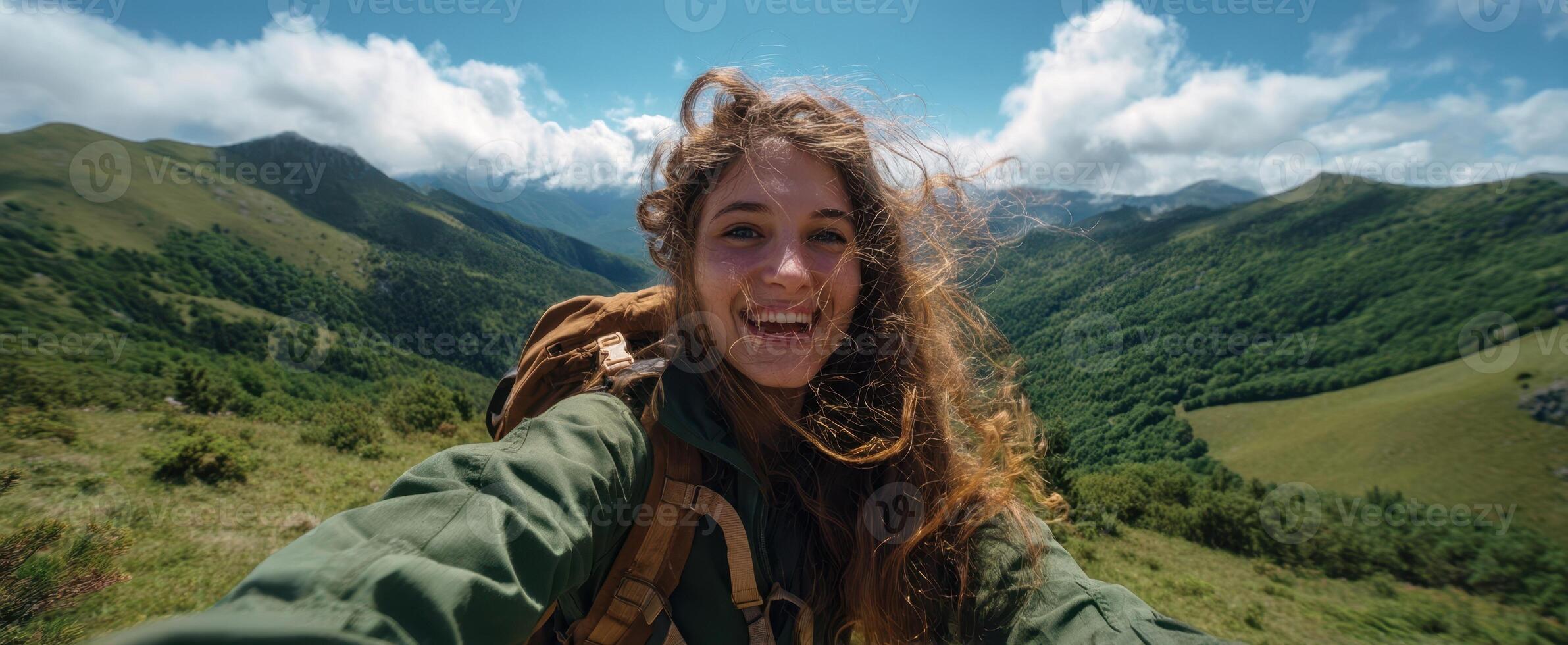 The adventurous young woman enjoying a sunny day in the mountains. photo