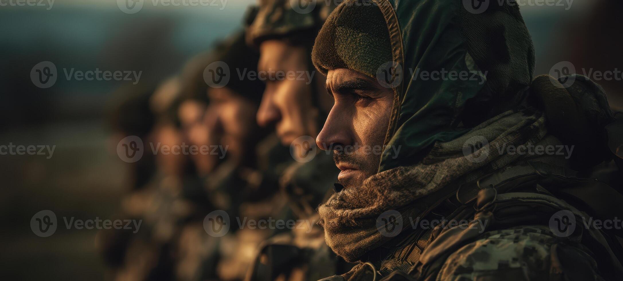 The soldiers standing in formation exhibiting camaraderie and determination at dusk. photo