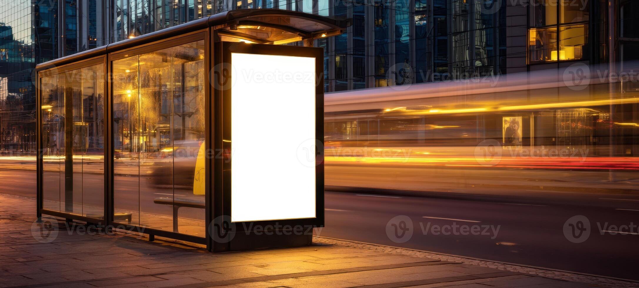 The bus station shelter with empty advertising space at night in the city. photo