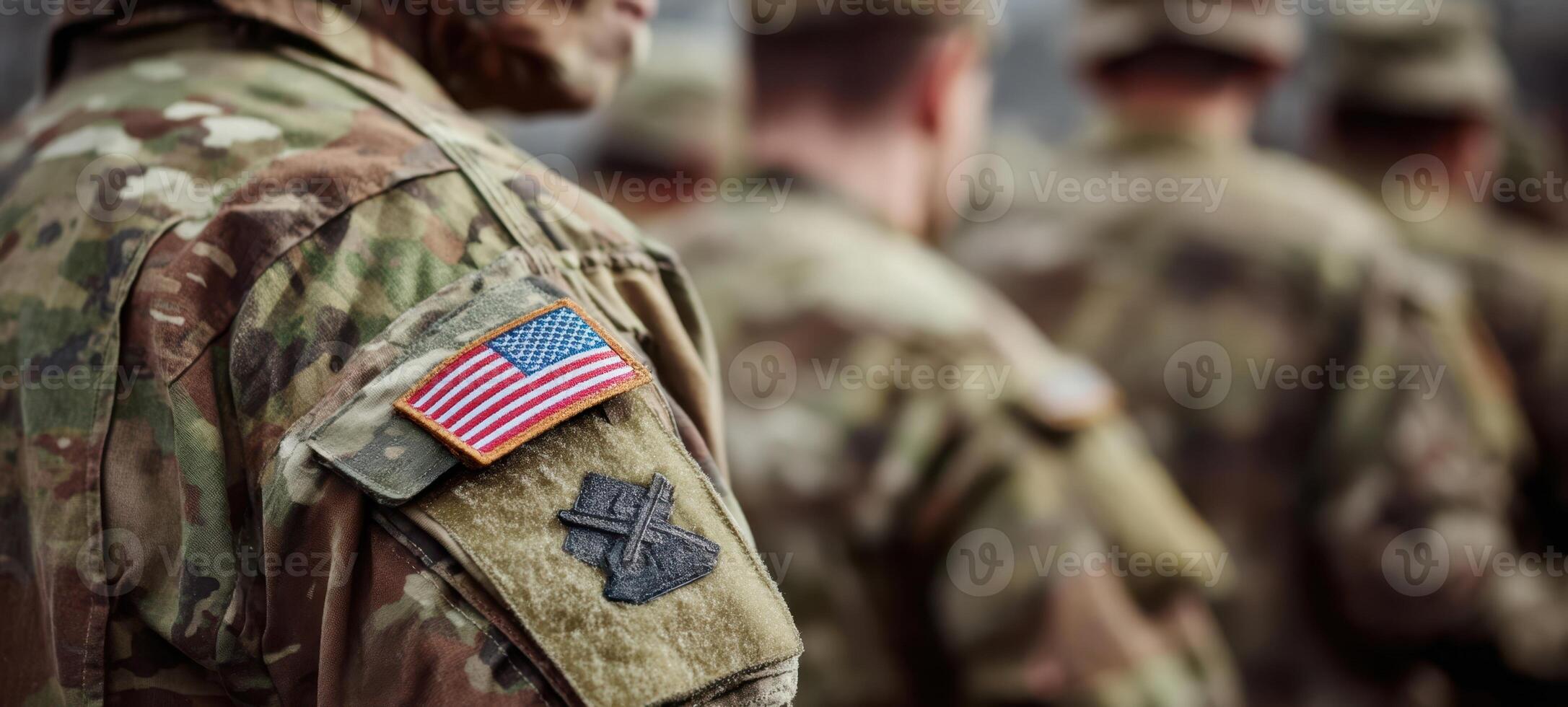 The soldier in military uniform proudly displays an American flag patch. photo