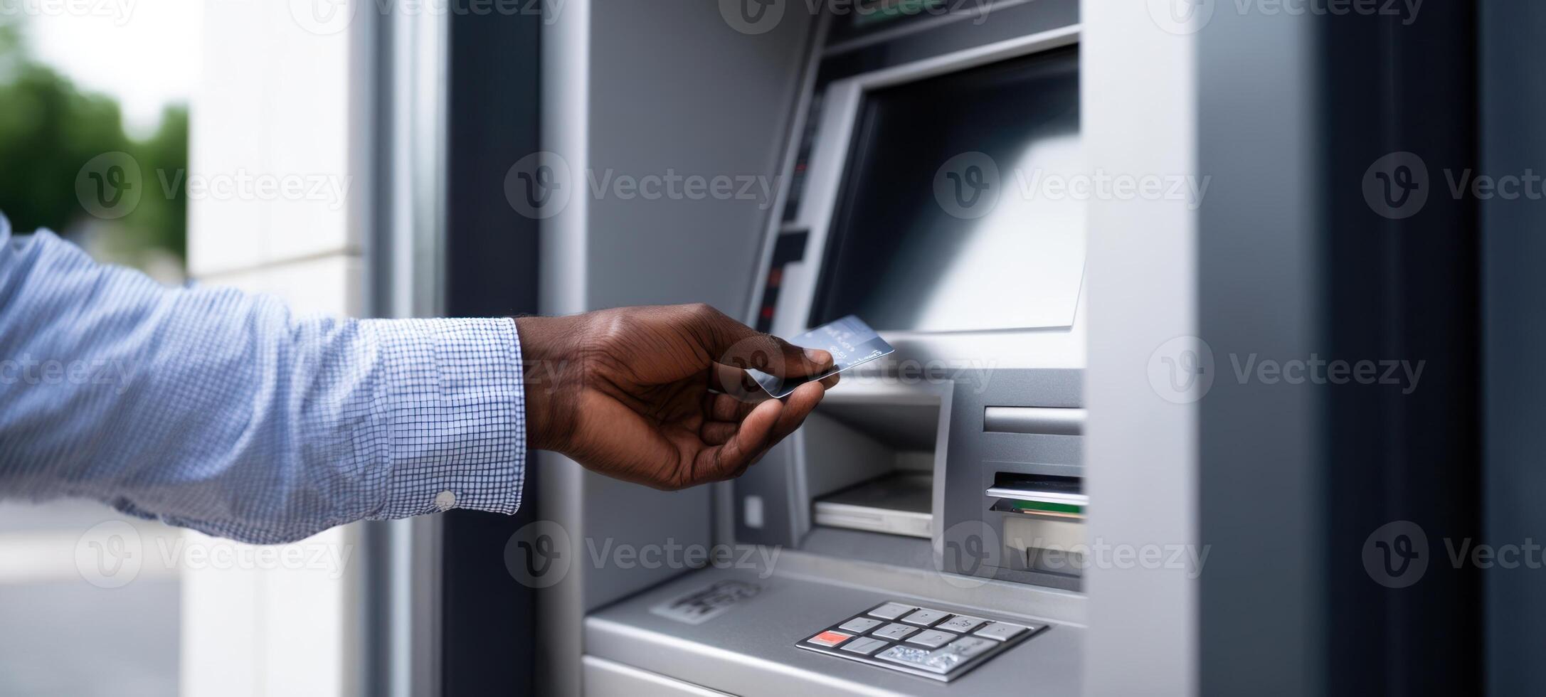 The hand inserting a card into an ATM for cash withdrawal. photo
