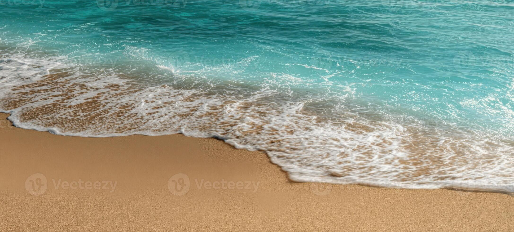 The tranquil beach scene with gentle waves and clear turquoise waters. photo