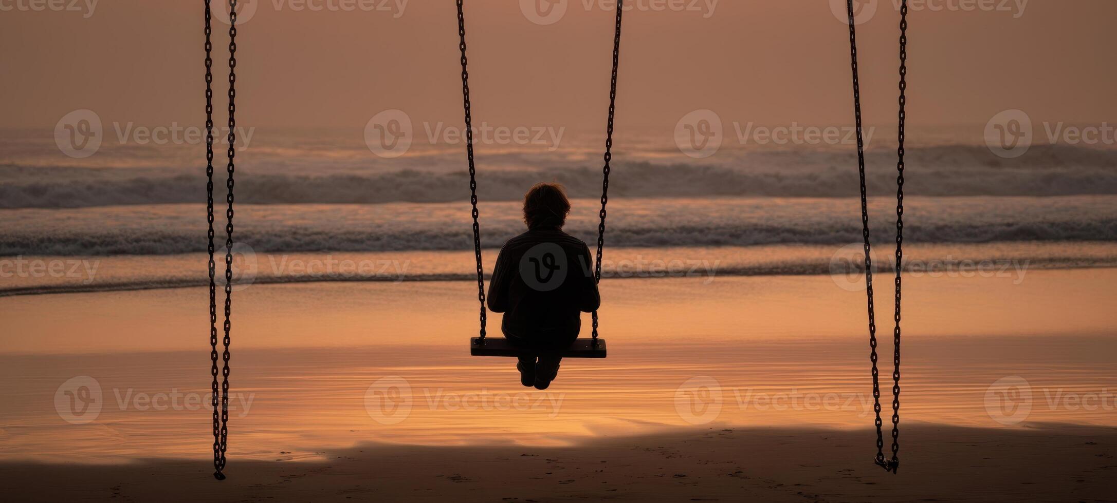The swing overlooking the serene beach at sunset for moments of reflection. photo
