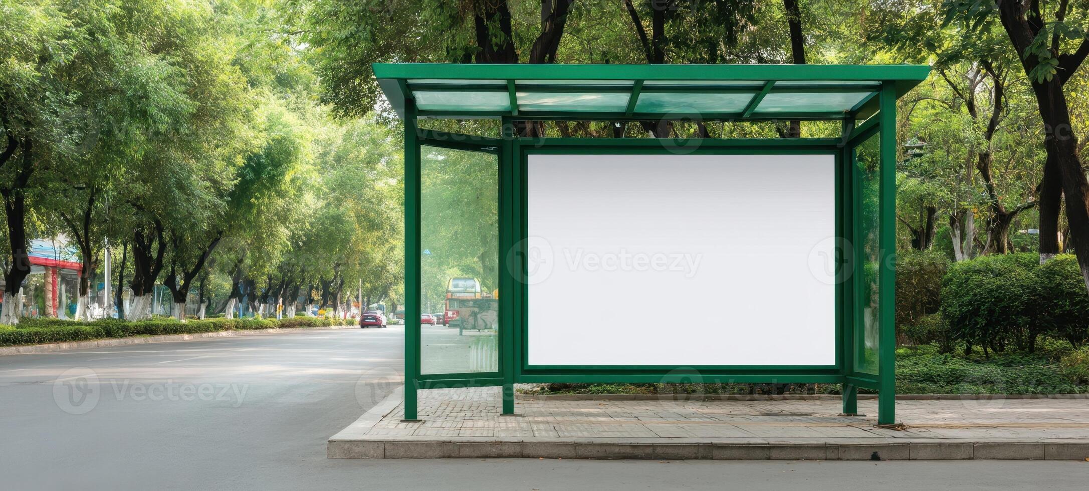 The empty bus stop shelter amid lush green scenery in a quiet urban area. photo