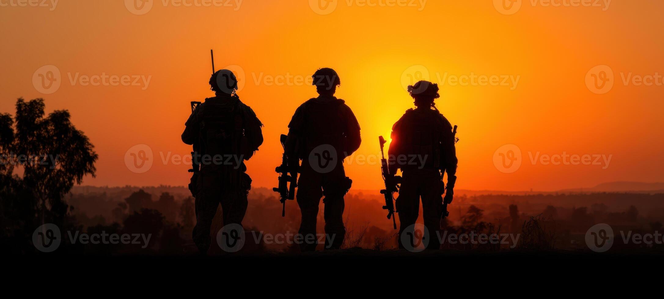 The soldiers standing united against a dramatic sunset backdrop. photo