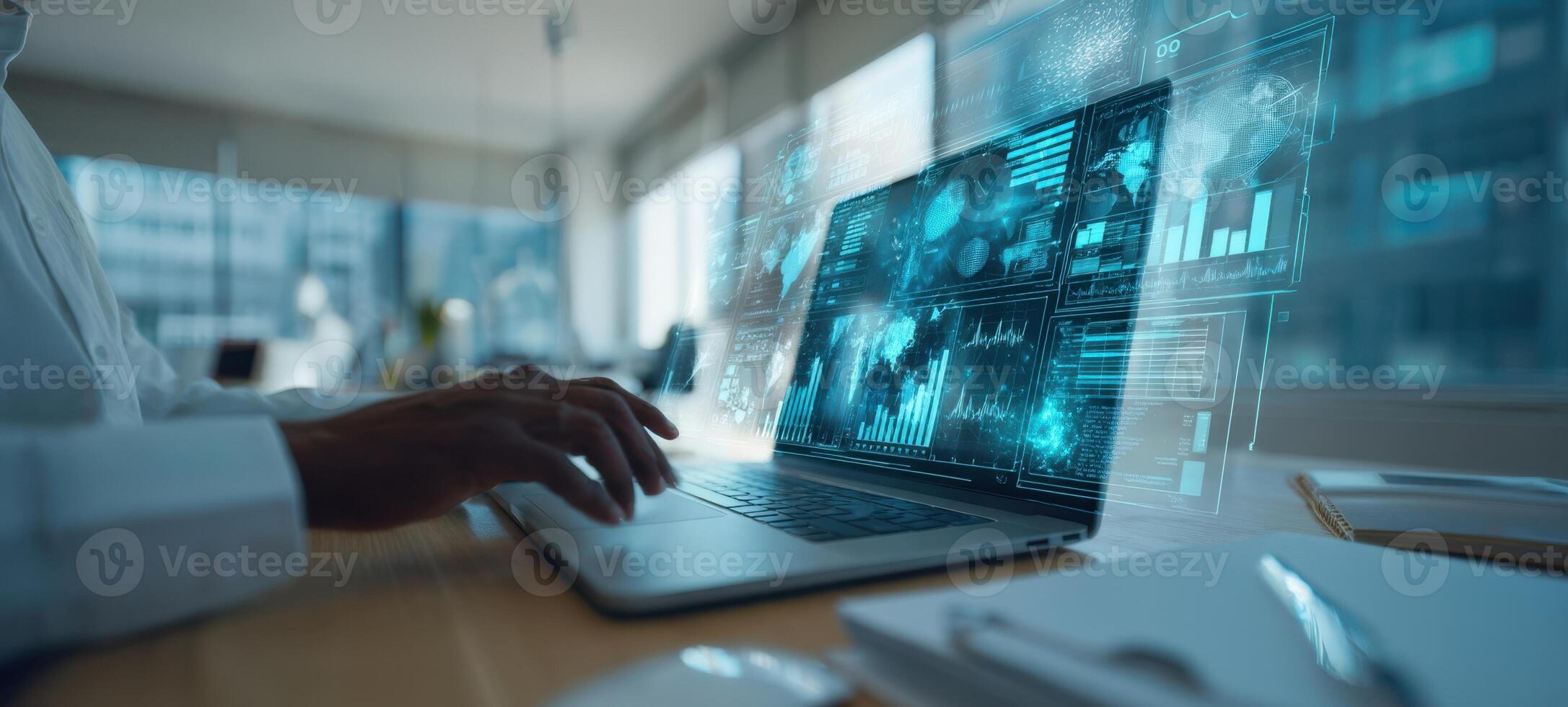 The laptop displaying futuristic data analytics in a modern workspace setting. photo