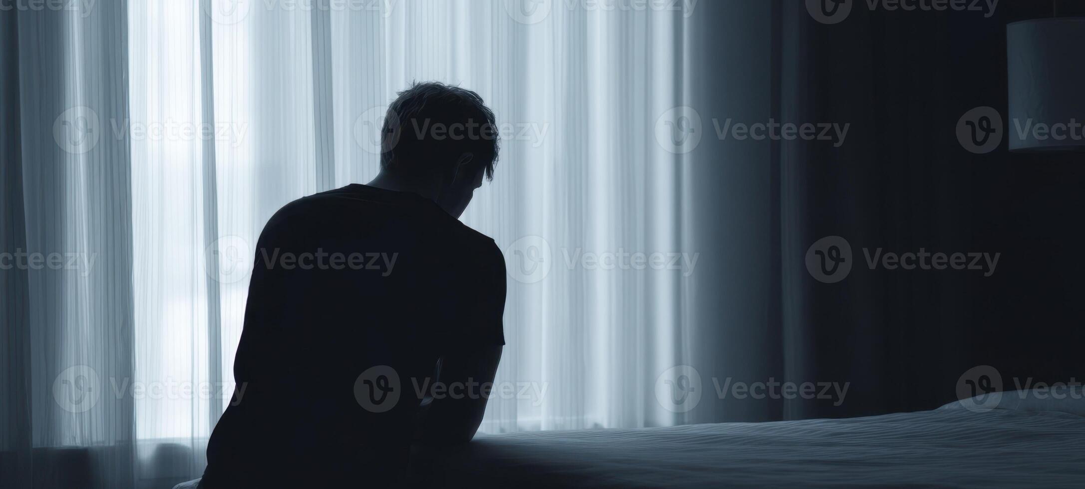 The silhouette of a man reflecting in a dimly lit hotel room photo