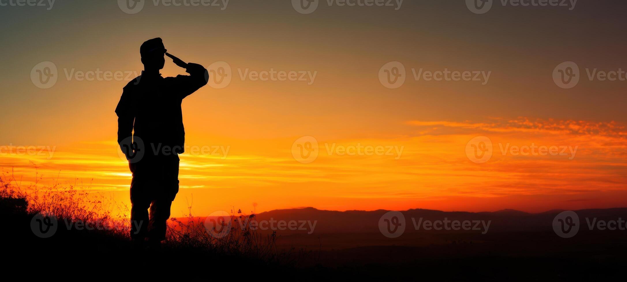 The soldier saluting against a vibrant sunset backdrop of honor and respect. photo