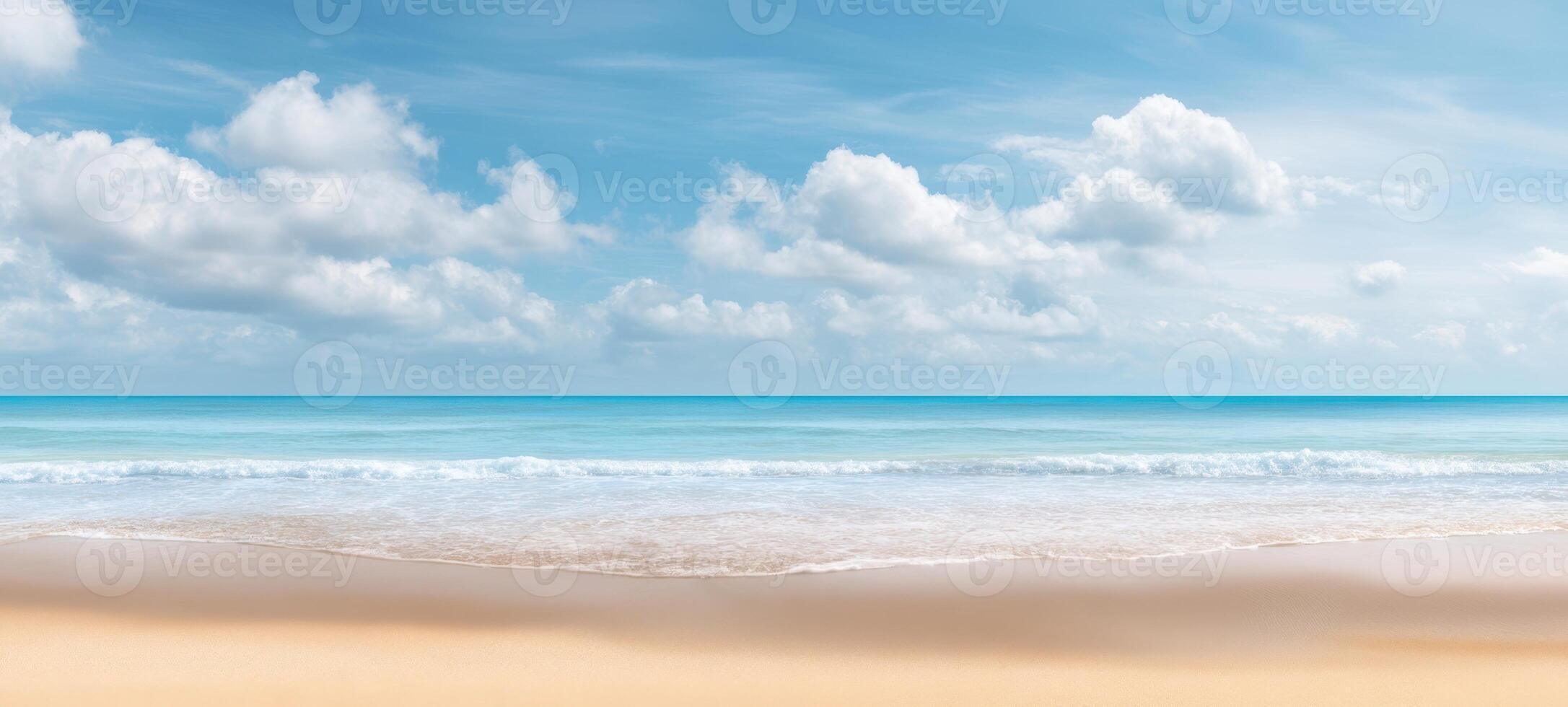 The serene beach with gentle waves under a bright blue sky photo