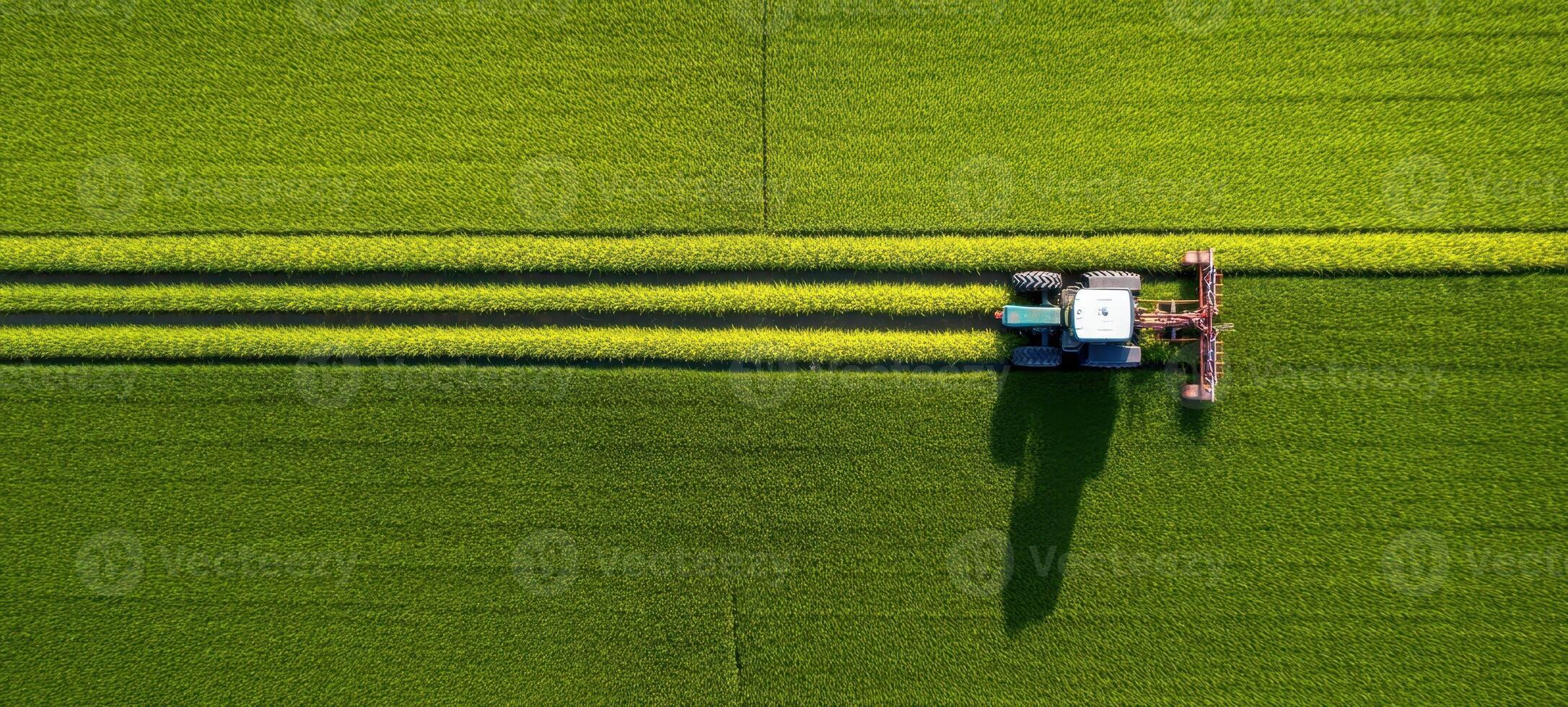 The aerial view of a tractor cultivating a vibrant green field. photo