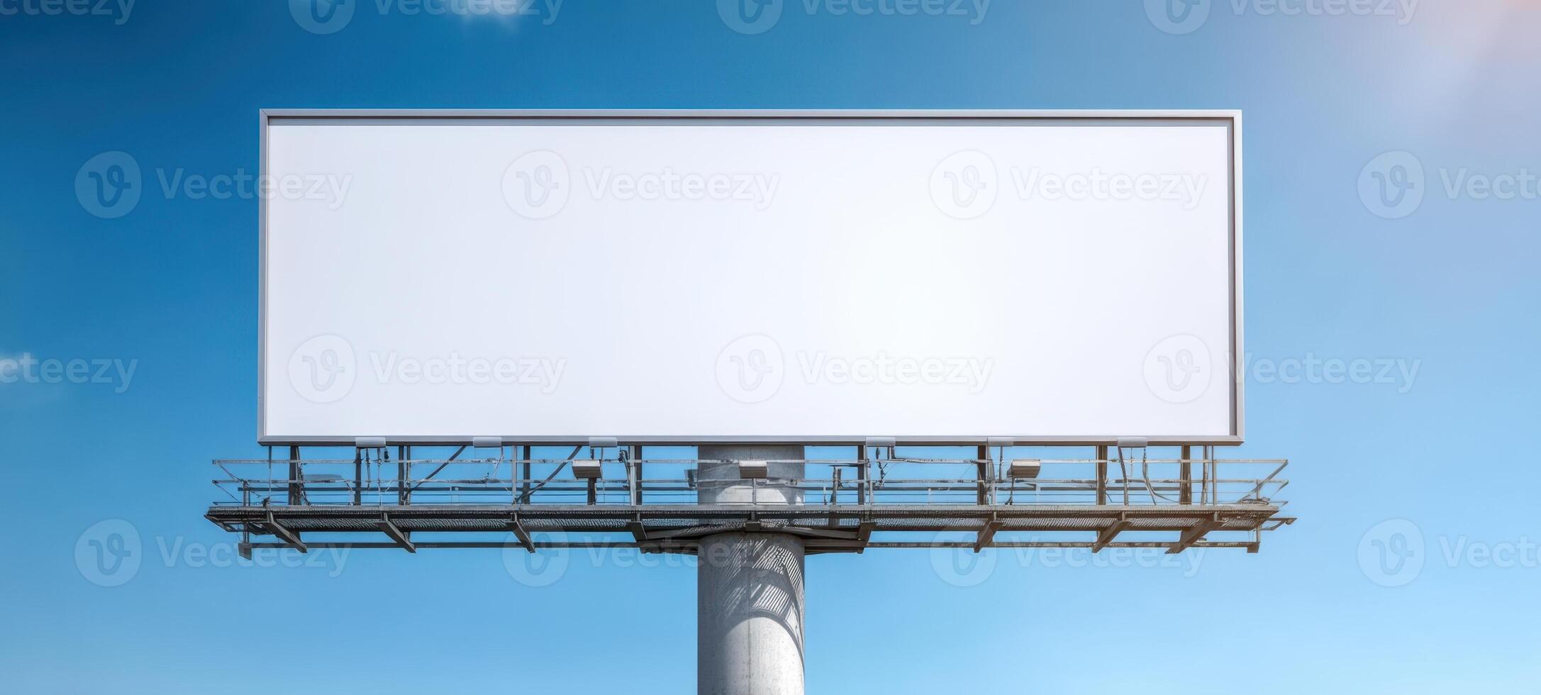 The empty billboard under a clear blue sky waiting for new advertisements. photo