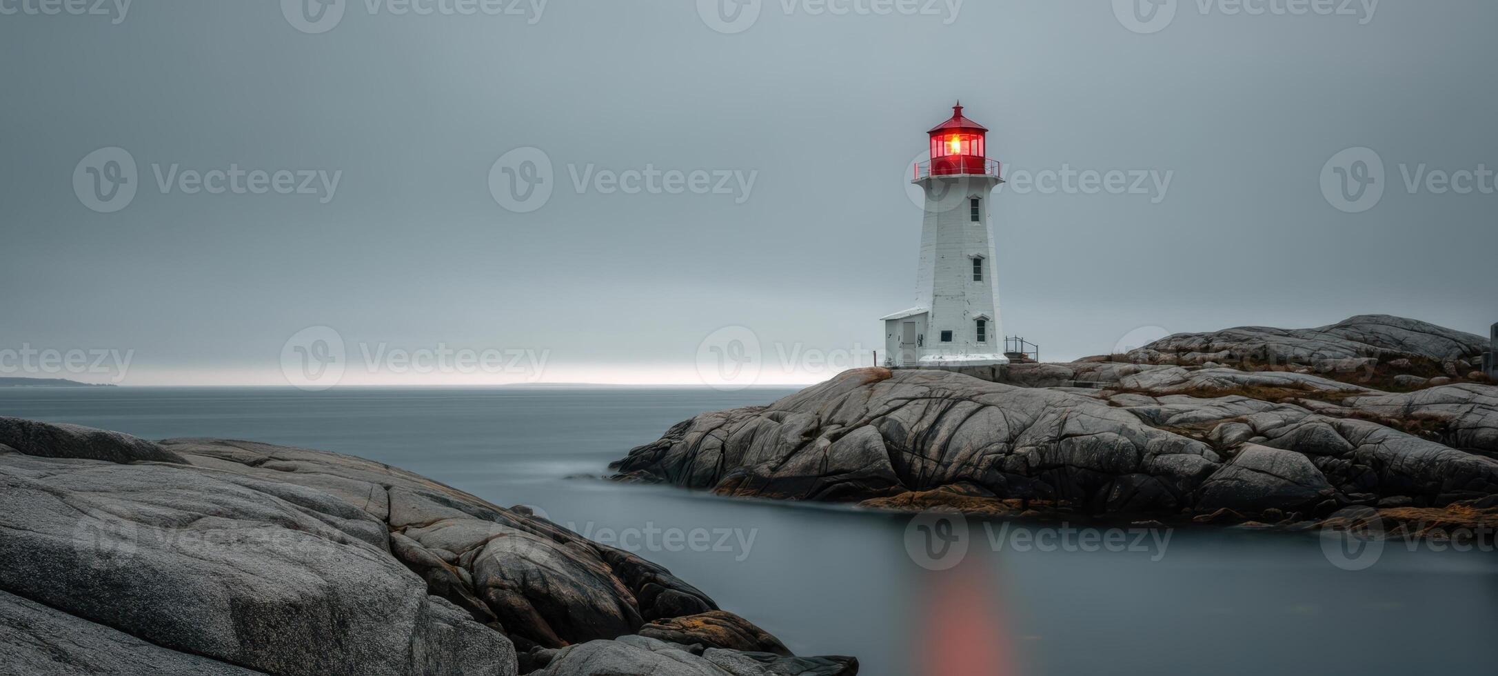 The iconic lighthouse stands resilient against the moody ocean backdrop. photo