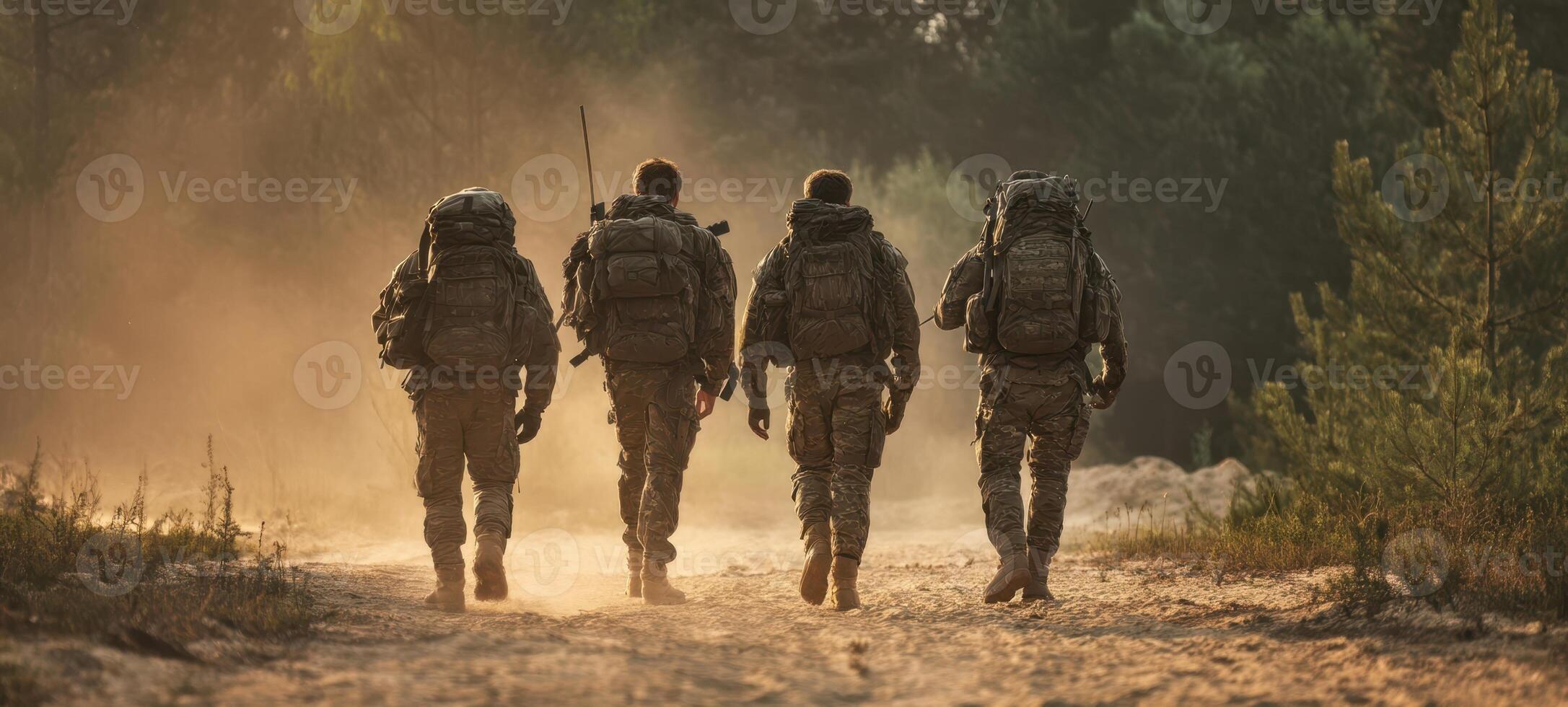 The soldiers marching forward in a dusty, sunlit wilderness setting. photo