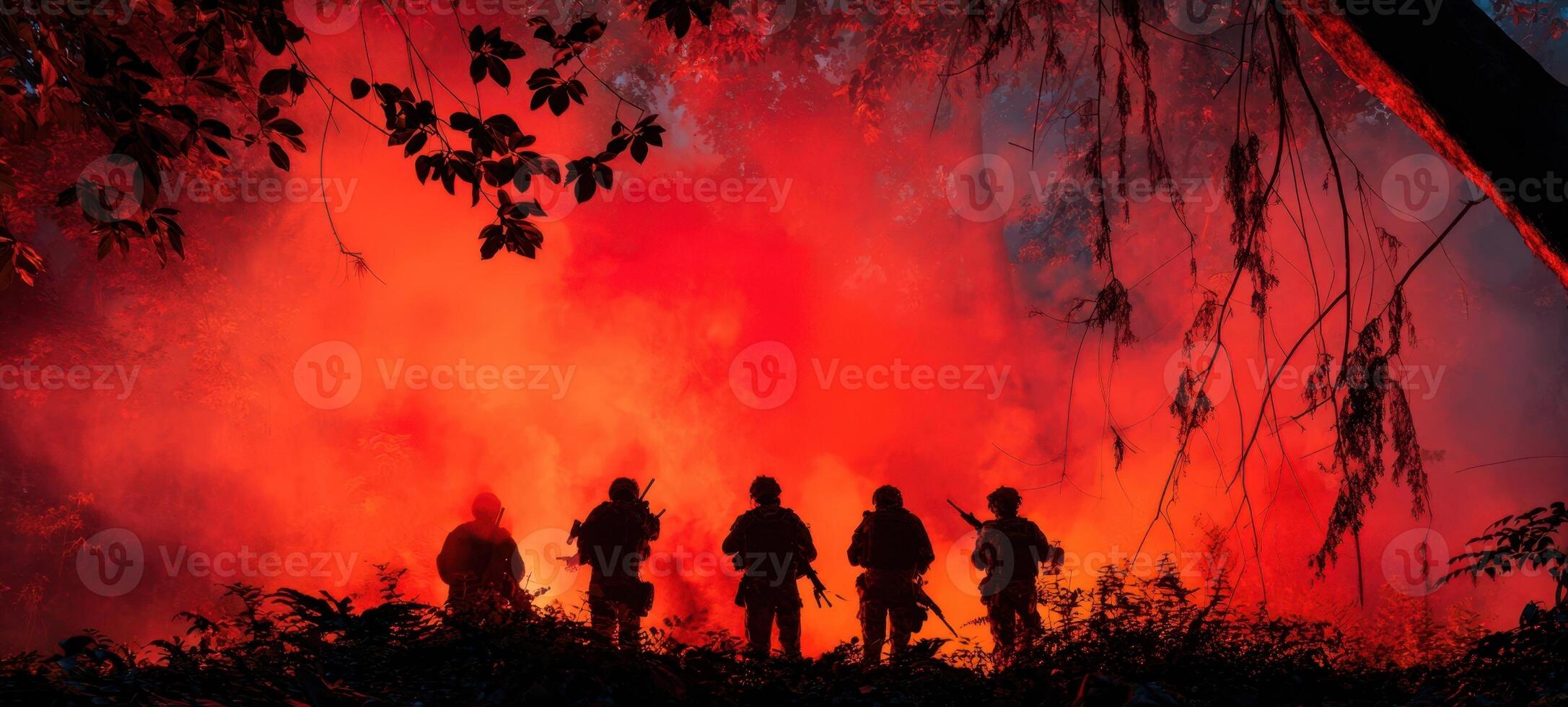 The silhouettes of firefighters battling a raging wildfire under a fiery sky. photo