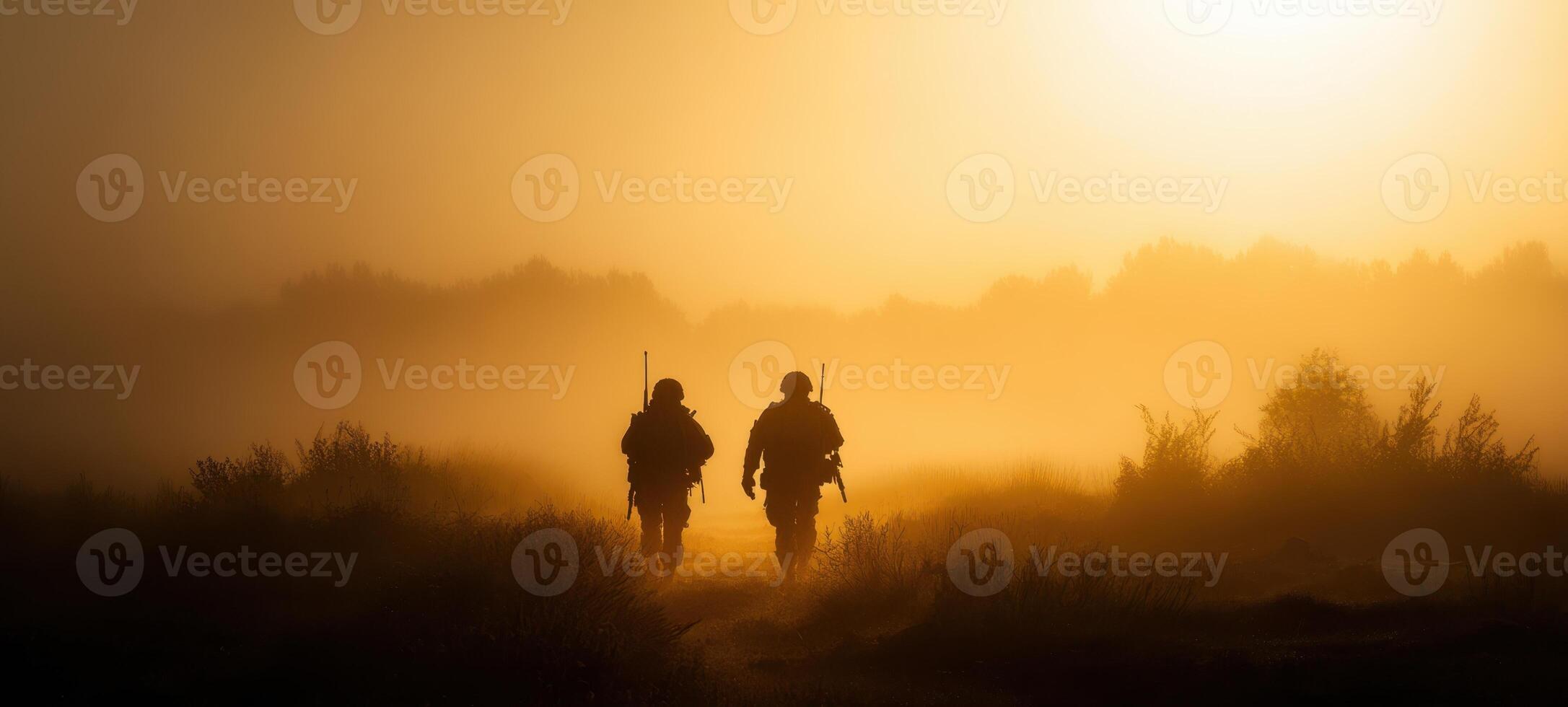 The soldiers walking through fog at sunrise in a tranquil landscape. photo