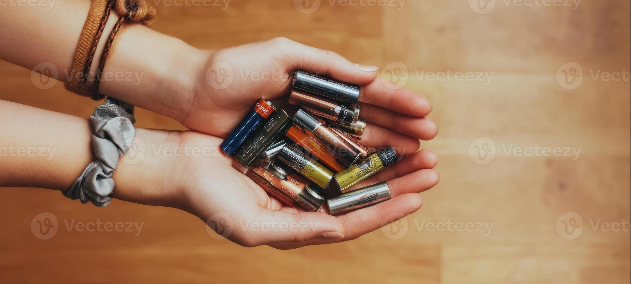 The hands holding a variety of batteries showcasing energy and technology. photo