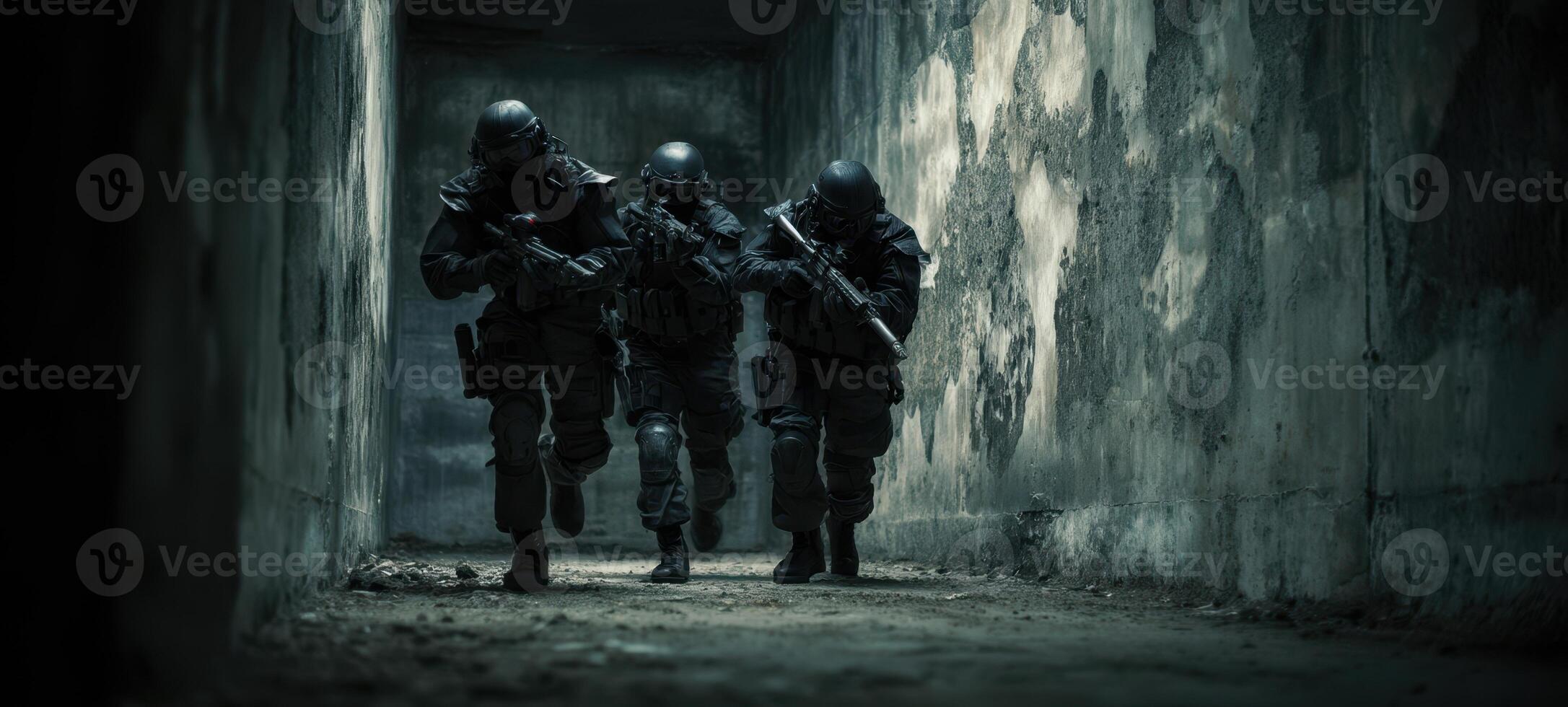 The soldiers advancing through a dark corridor in tactical formation. photo
