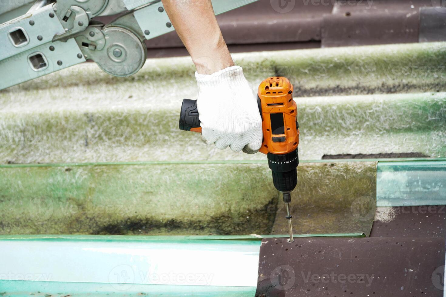 Construction workers install new roofs, roofing tools, electric drills used for roof drills. photo