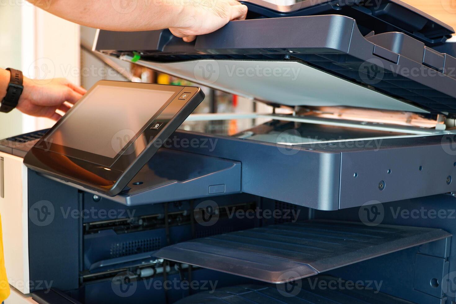 Men press the button of the copier. Man copying paper from Photocopier. Men use printing machines. man using photocopier photo