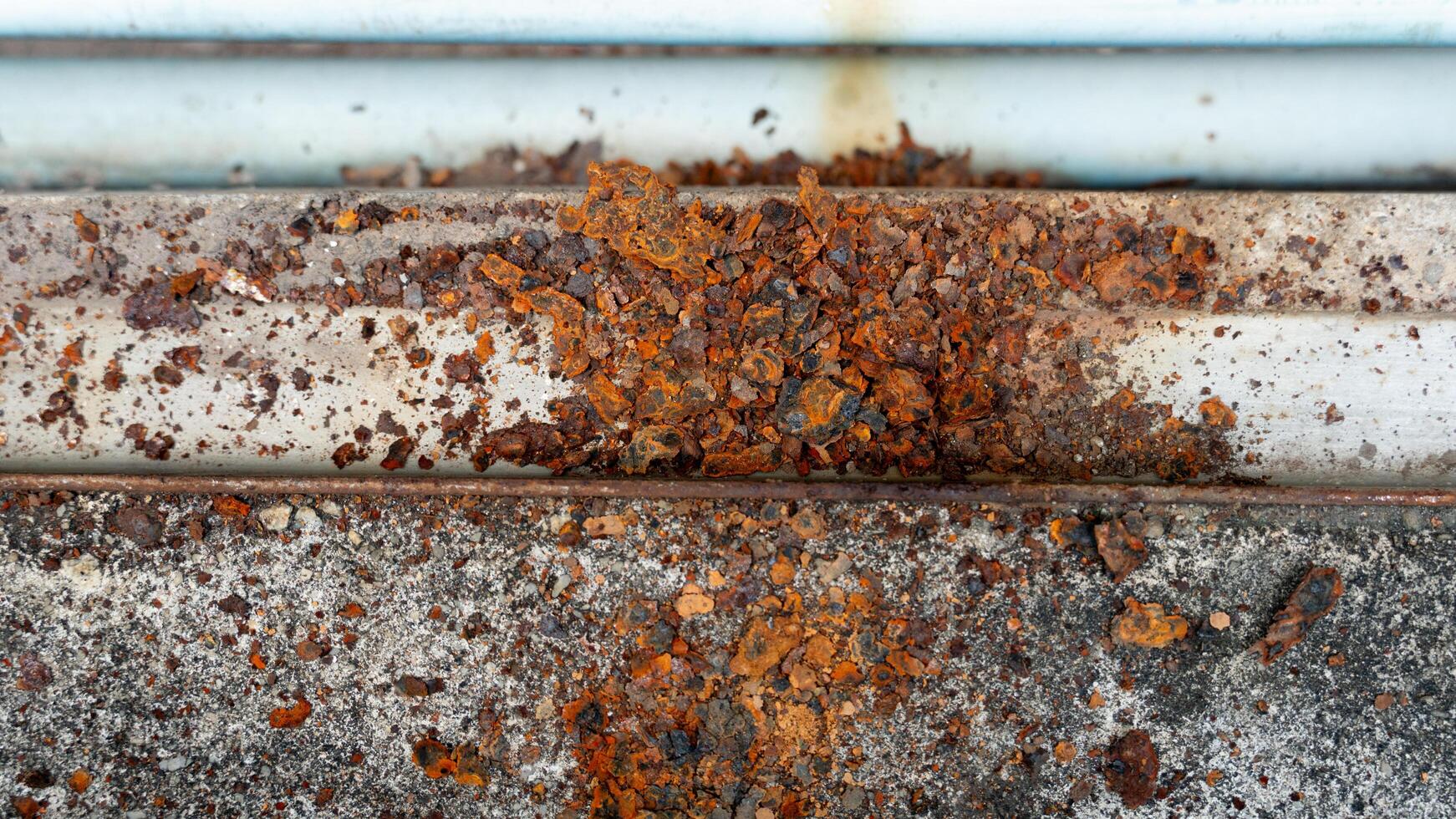 Heavily rusted and corroded metal surface. Layers of peeling. Reddish brown rust are prominent. photo
