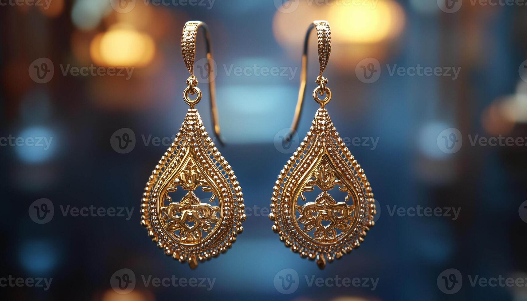 Gold earrings on a blurred background photo