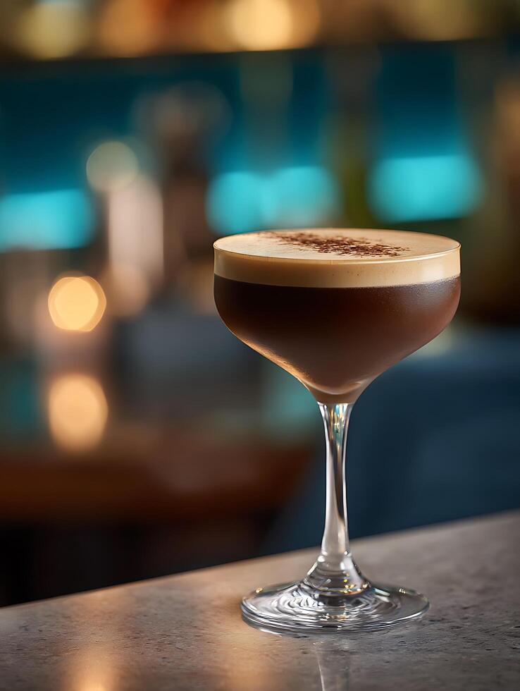 Espresso Martini Cocktail in Coupe Glass on Bar Counter. A close up of a delicious espresso martini, garnished with cocoa powder, sits on a bar top with a blurred background. photo
