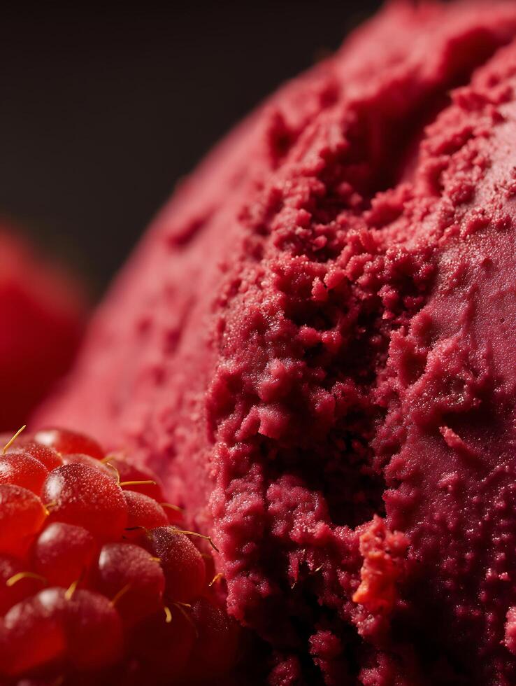 Close Up of Raspberry Sorbet with Fresh Raspberries. A detailed image showing the texture and color of homemade raspberry sorbet. photo