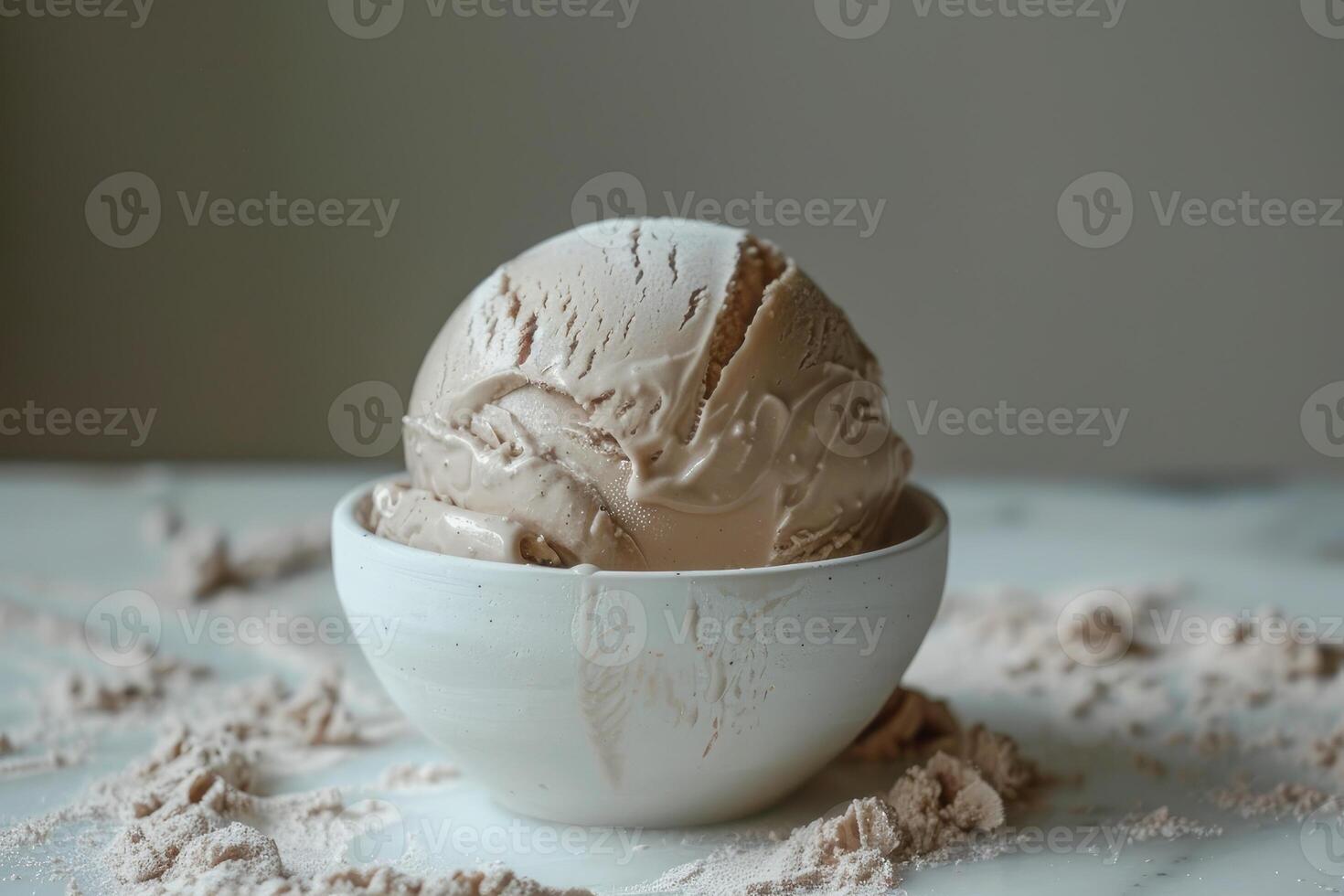 On the table, there is a bowl filled with delicious chocolate ice cream photo