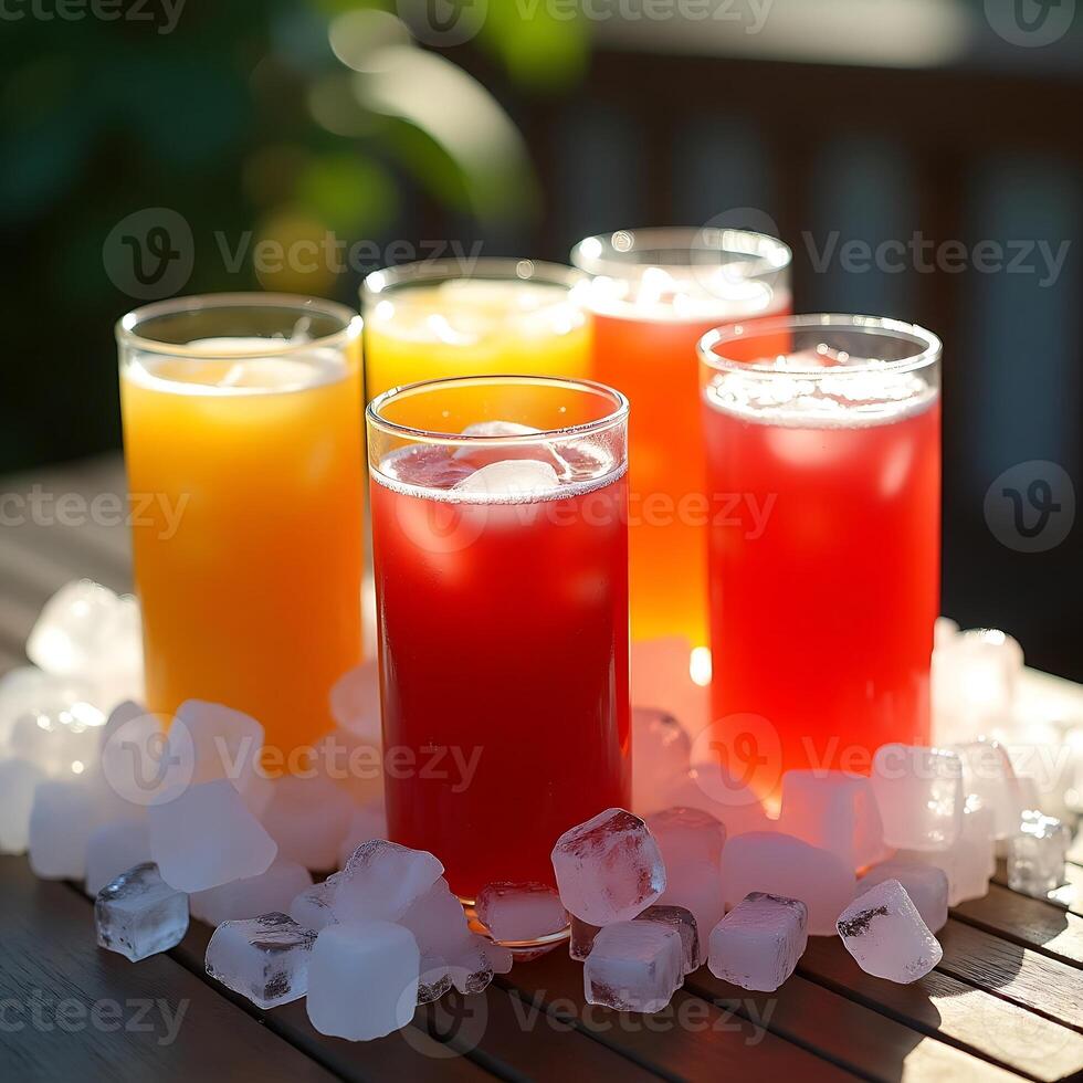 Refreshing Colorful Drinks with Ice Cubes on Wood Table photo