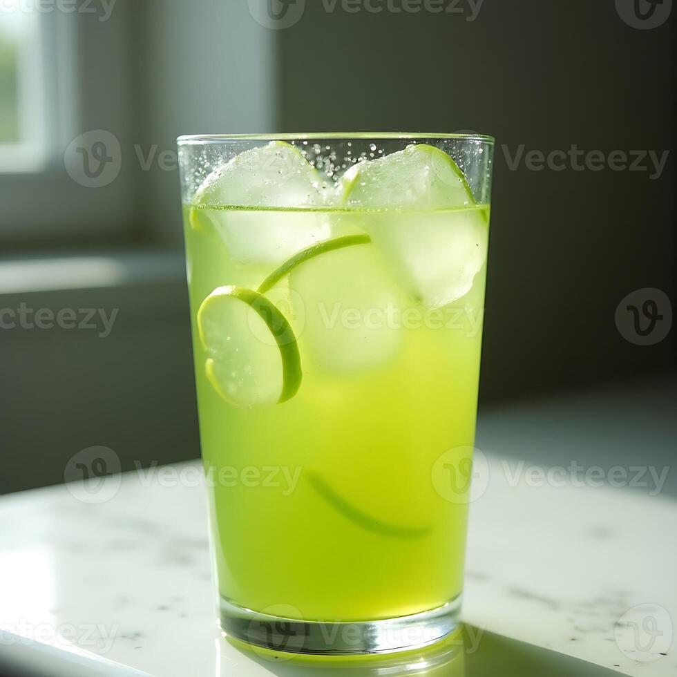 Refreshing Green Drink with Ice and Lime Slices in Glass photo