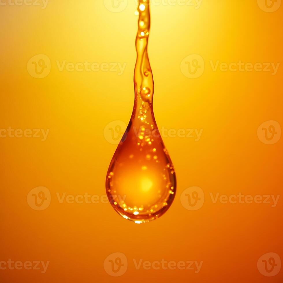 Golden Liquid Droplet Falling on Warm Background photo