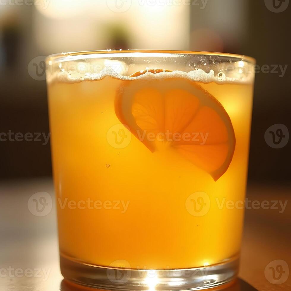 Refreshing Orange Drink with a Slice in Glass Close-up photo