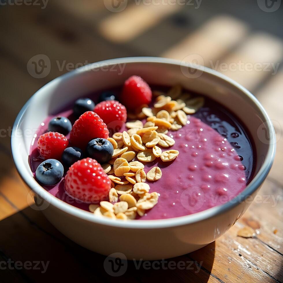 Eating Berry Smoothie Bowl with Granola and Fresh Berries photo