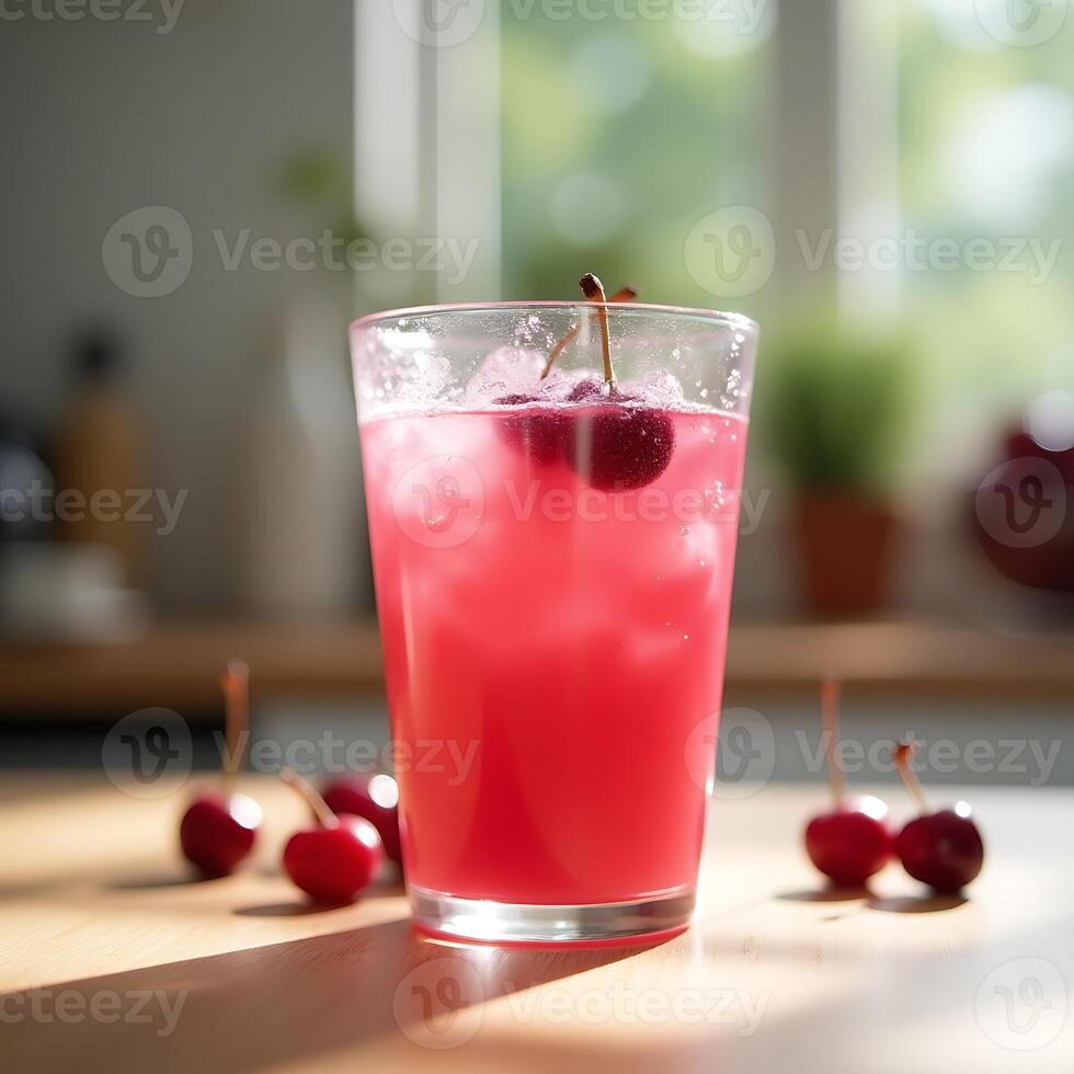 Refreshing Cherry Drink with Ice Cubes in Glass on Counter photo