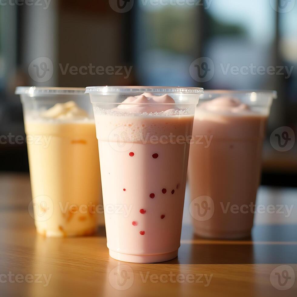 Fruit Smoothies in Plastic Cups on Wooden Tabletop photo